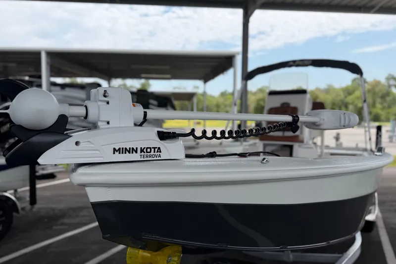 Slide: The Image of Avid 21 Fusion 2027 boat with Minn Kota Terrova motor in a covered dock. - 23