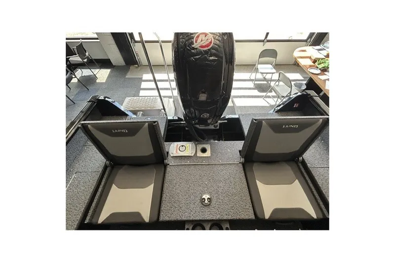Slide: The Image of 2027 Lund 1800 Adventure Sport boat interior with seating and motor. - 9