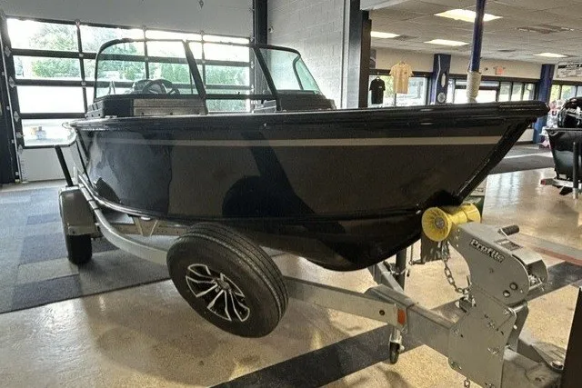 Slide: The Image of 2027 Lund 1800 Adventure Sport boat on trailer in showroom. - 3