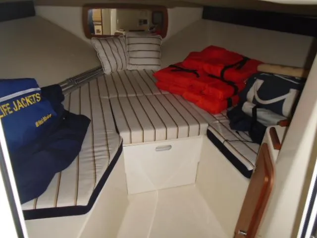 Slide: The Image of Interior of a 2012 Chris-Craft Corsair 28 with striped cushions and life jackets. - 11
