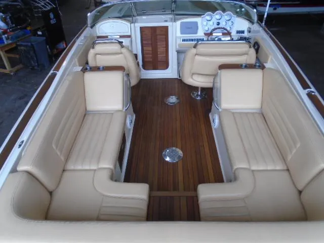 Slide: The Image of Interior view of a 2012 Chris-Craft Corsair 28 with elegant leather seating and wooden flooring. - 10