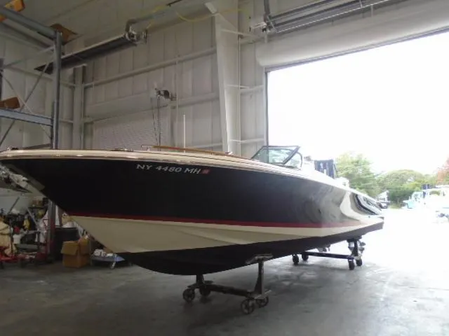 Slide: The Image of 2012 Chris-Craft Corsair 28 in a warehouse on a trailer. - 4