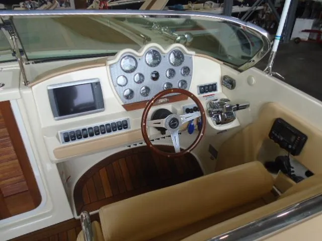 Slide: The Image of The image shows the cockpit of a 2012 Chris-Craft Corsair 28 with an elegant dashboard. - 9