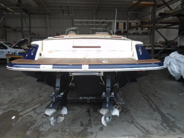 Slide: The Image of The image shows the stern of a 2012 Chris-Craft Corsair 28 in a storage facility. - 5