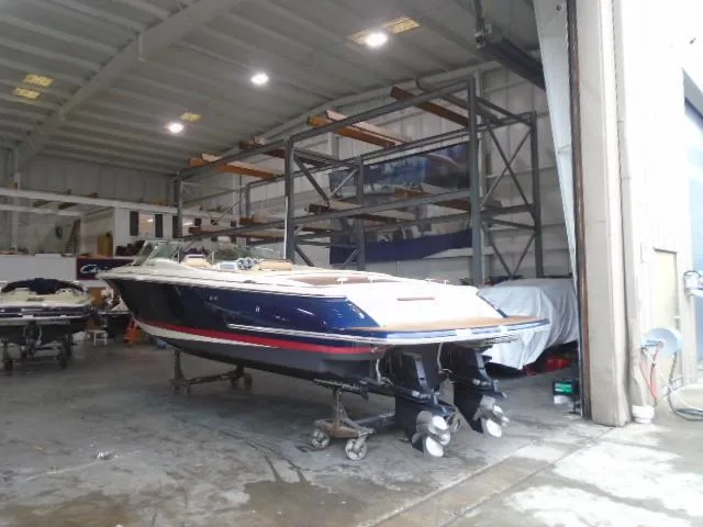 Slide: The Image of A 2012 Chris-Craft Corsair 28 is in a storage facility. - 6
