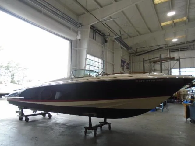 Slide: The Image of A 2012 Chris-Craft Corsair 28 is situated in a spacious warehouse. - 1