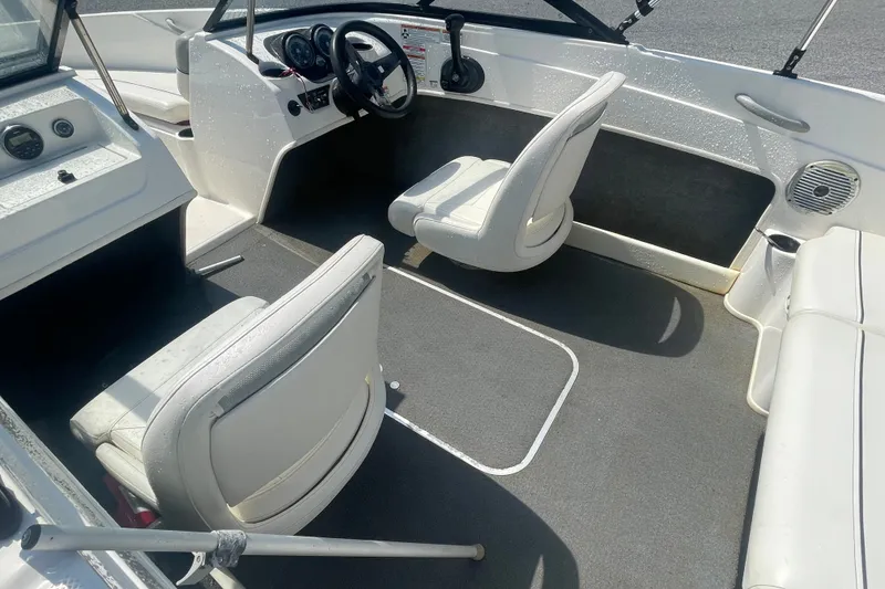 Slide: The Image of 2017 Bayliner 170 Bowrider interior with white seating and steering console. - 14