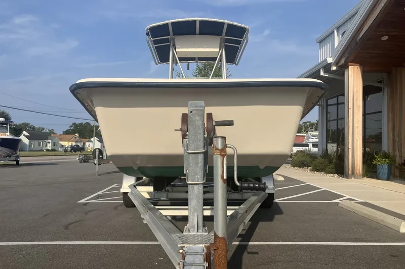 Slide: The Image of Jones Brothers Bateau 19 boat on trailer, parked outdoors, front view, sunny day. - 4