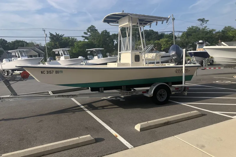 Slide: The Image of 2005 Jones Brothers Bateau 19 boat on trailer in parking lot, sunny day. - 3