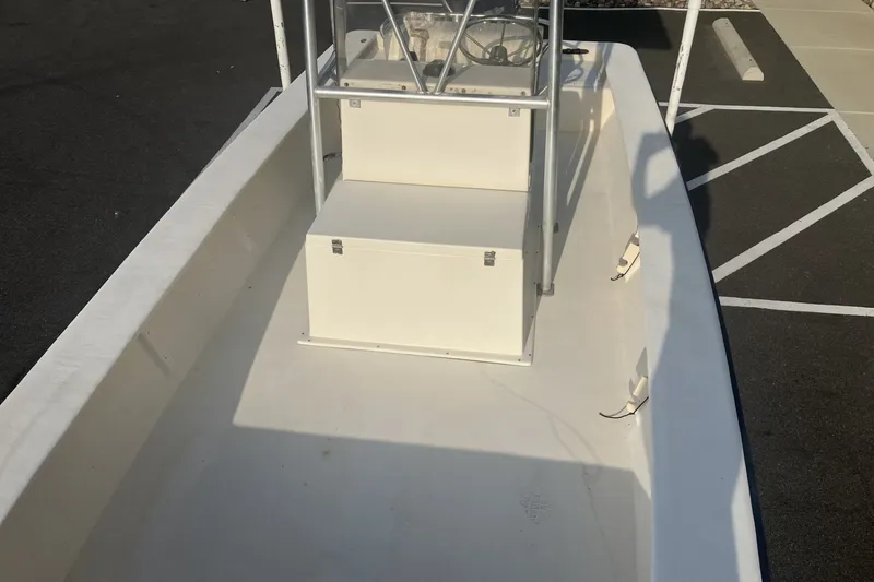 Slide: The Image of 2005 Jones Brothers Bateau 19 boat interior with steering console and storage. - 11