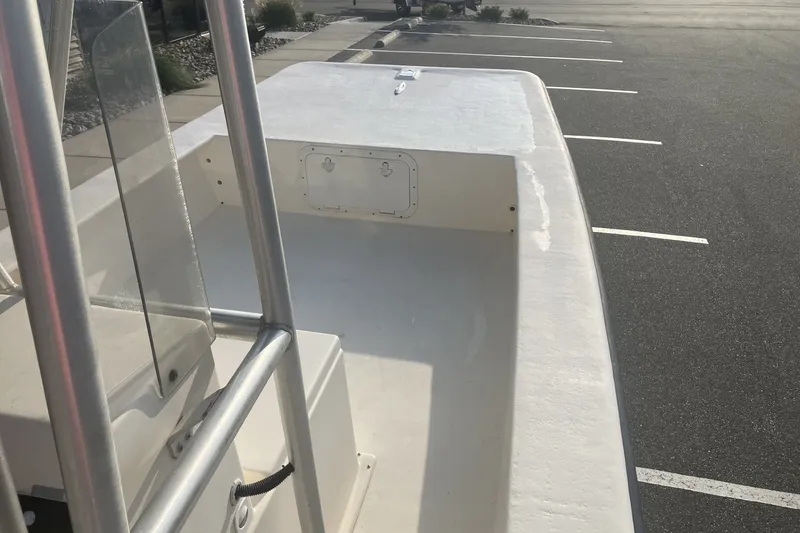 Slide: The Image of 2005 Jones Brothers Bateau 19 boat parked in a lot, showcasing its deck and railing. - 13