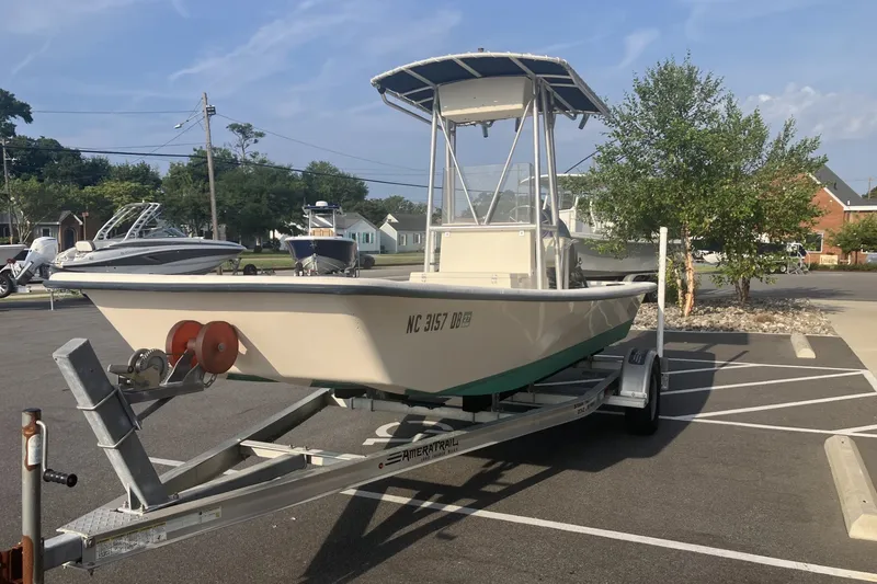 Slide: The Image of 2005 Jones Brothers Bateau 19 boat on trailer in parking lot, sunny day. - 6