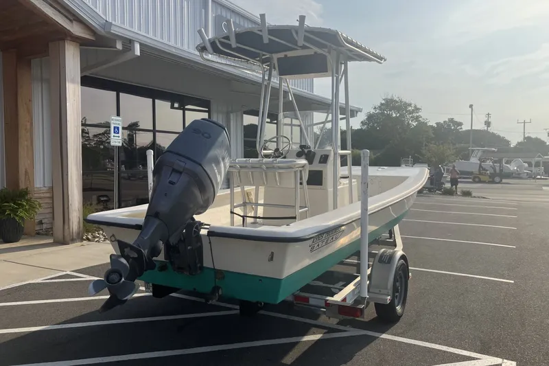 Slide: The Image of Jones Brothers Bateau 19 boat, 2005 model, parked on a trailer outside a building. - 7