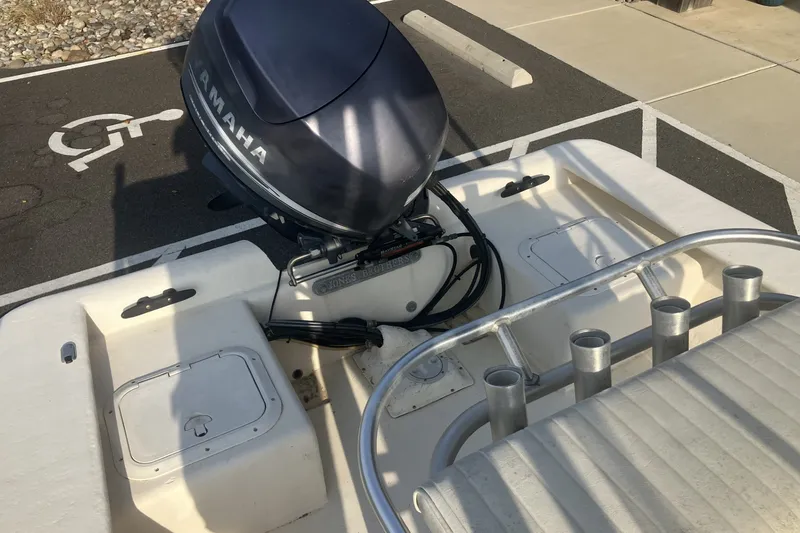 Slide: The Image of 2005 Jones Brothers Bateau 19 boat with Yamaha outboard motor in parking area. - 10