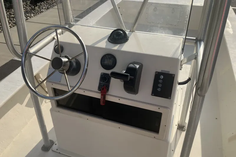 Slide: The Image of 2005 Jones Brothers Bateau 19 boat console with steering wheel and controls. - 9