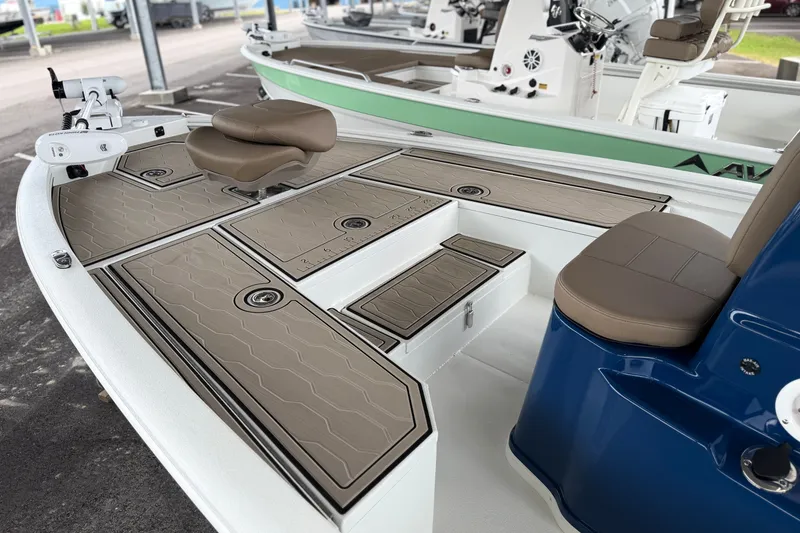 Slide: The Image of 2027 Avid 21 FSX boat interior with tan seating and storage compartments. - 17