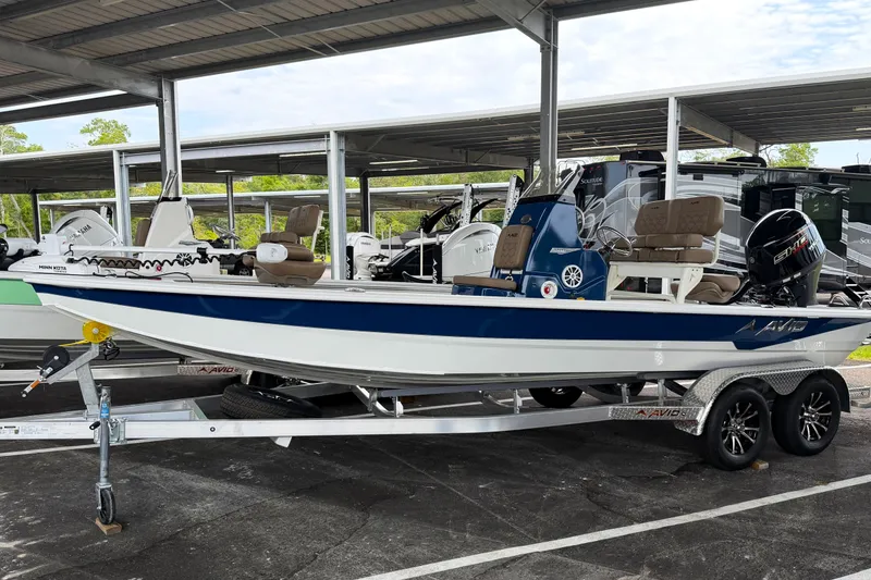 The Image of 2027 Avid 21 FSX boat on trailer under covered parking. - 0