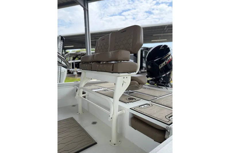 Slide: The Image of 2027 Avid 21 FSX boat interior with cushioned seating and storage compartments. - 14