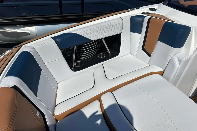 Slide: The Image of 2019 Nautique Super Air Nautique G21 interior with white, blue, and brown seating. - 20