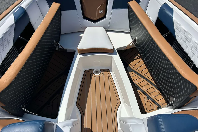 Slide: The Image of 2019 Nautique Super Air Nautique G21 interior with tan and blue seating. - 22