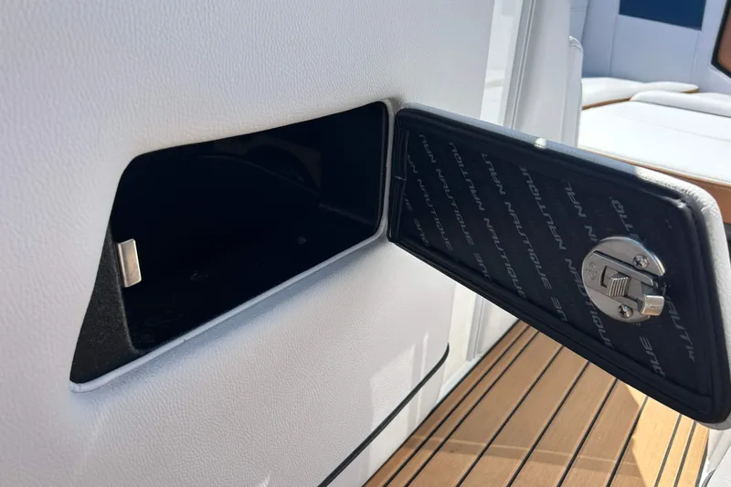 Slide: The Image of Storage compartment on 2019 Nautique Super Air Nautique G21 boat with open latch. - 16