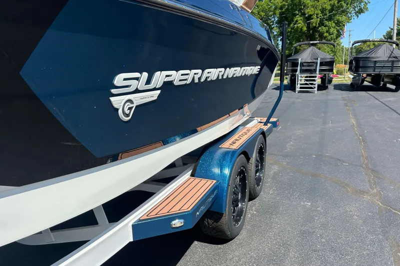 Slide: The Image of 2019 Nautique Super Air Nautique G21 boat on trailer in parking lot. - 26