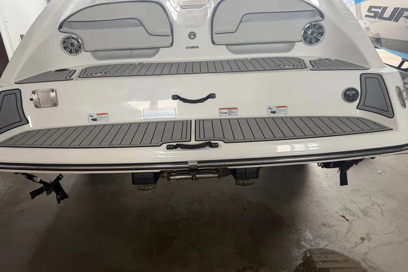 Slide: The Image of 2015 Yamaha Boats 212X rear view, featuring swim platform and speakers. - 2