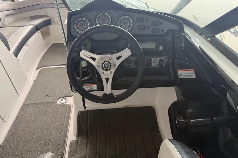 Slide: The Image of 2015 Yamaha Boats 212X cockpit with steering wheel and dashboard controls. - 3