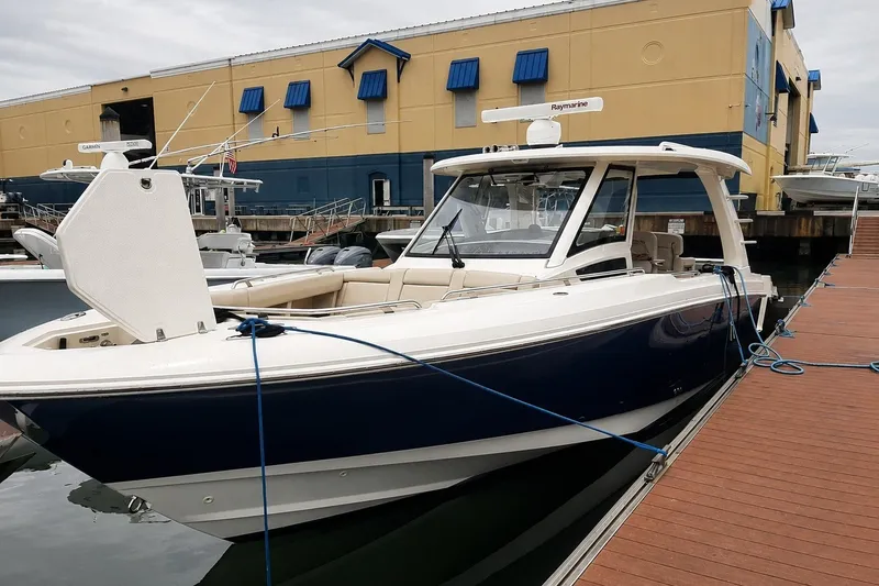 The Image of 2019 Boston Whaler 350 Realm docked at marina, showcasing sleek design and modern features. - 0