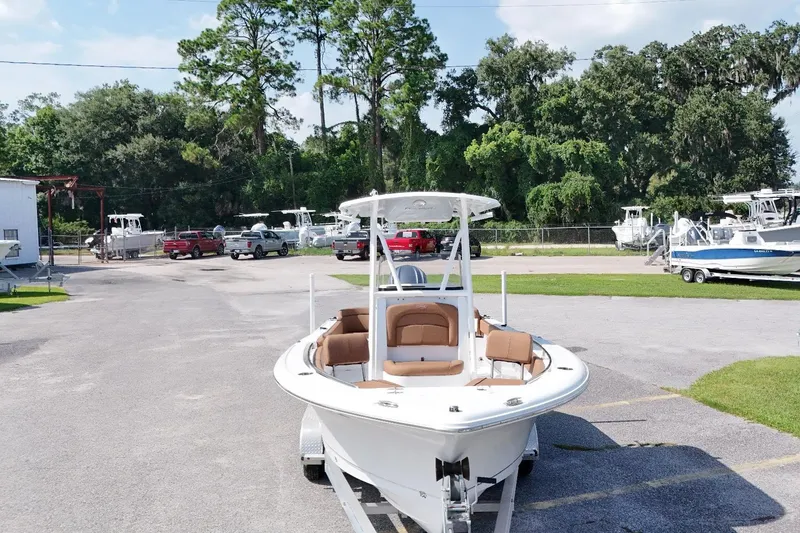 Slide: The Image of 2022 Sea Hunt Ultra 229 boat on trailer in outdoor dealership lot. - 14