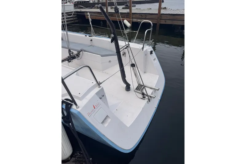 Slide: The Image of 2015 Catalina 275 Sport sailboat docked, showcasing a clean deck and sleek design. - 3