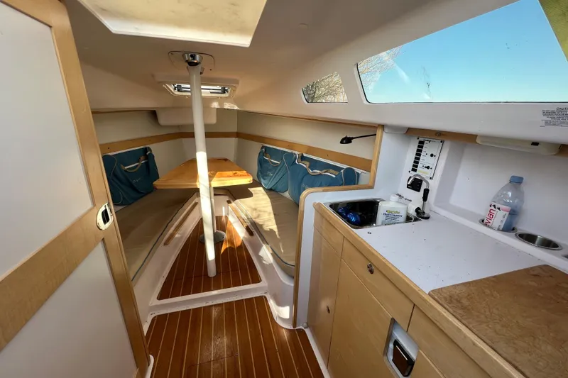 Slide: The Image of Interior of a 2015 Catalina 275 Sport sailboat with cozy seating and kitchenette. - 4