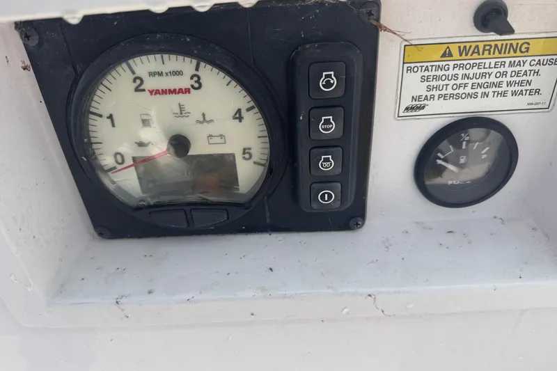 Slide: The Image of Control panel of a 2015 Catalina 275 Sport with Yanmar RPM gauge and warning label. - 7