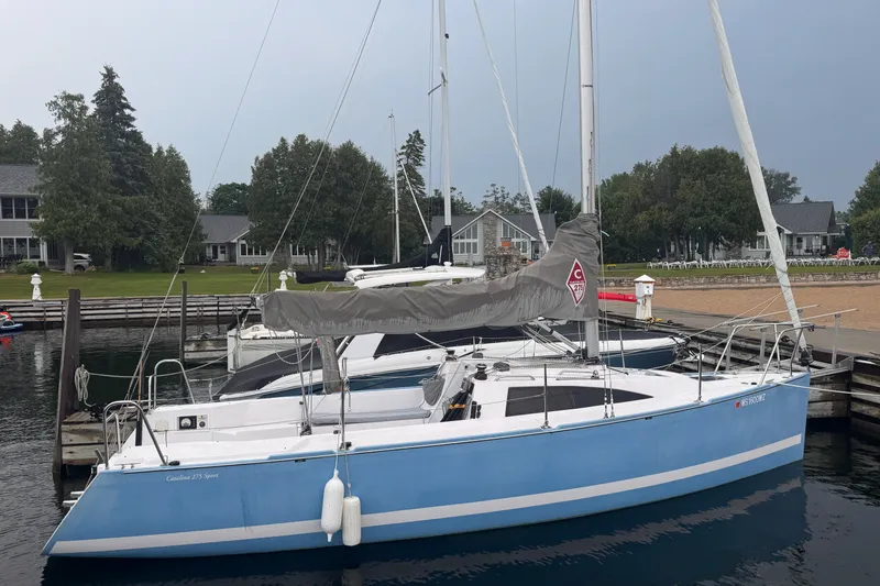 The Image of 2015 Catalina 275 Sport sailboat docked at a marina with scenic background. - 0