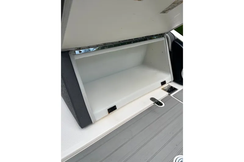 Slide: The Image of 2024 Yamaha AR250 boat storage compartment, open and empty, showcasing interior space. - 16