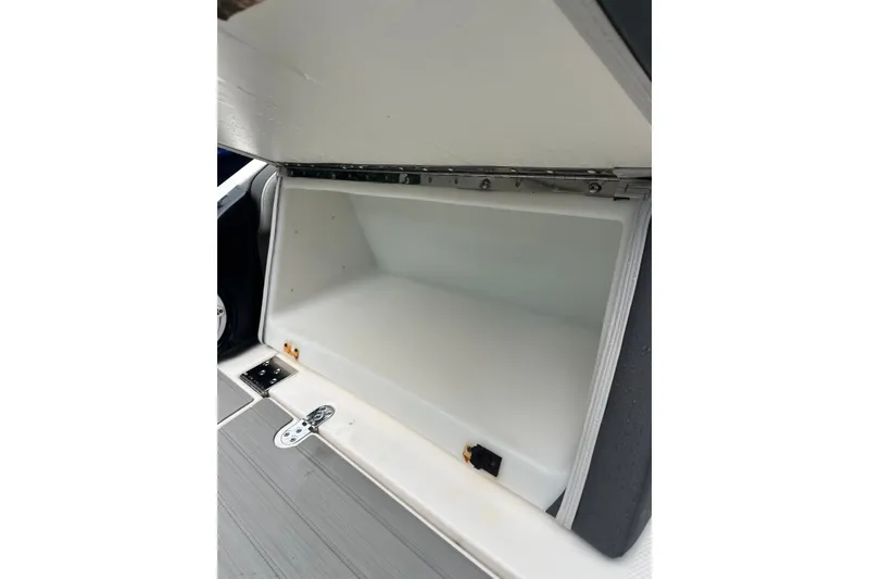 Slide: The Image of Open storage compartment on 2024 Yamaha Boats AR250, showcasing spacious interior design. - 15