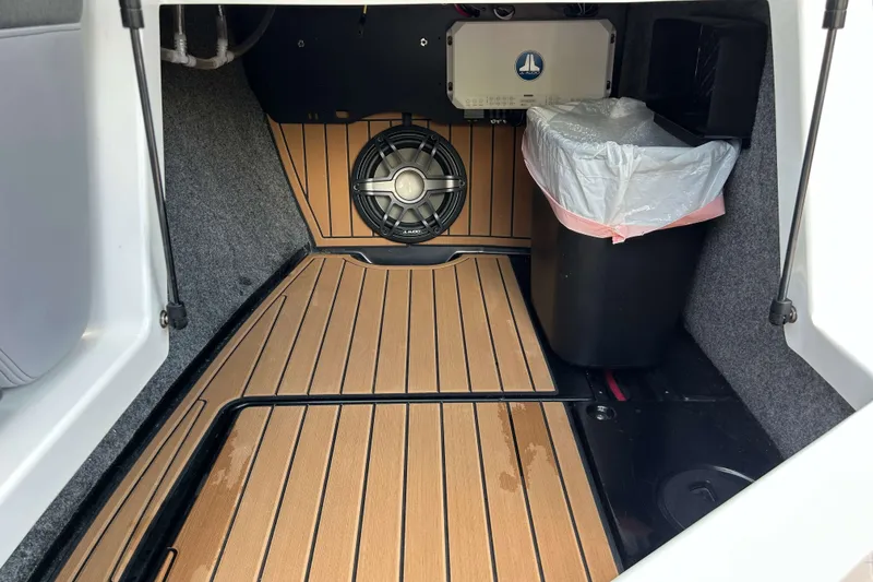 Slide: The Image of 2022 Nautique Super Air Nautique G21 interior storage with speaker and trash bin. - 19