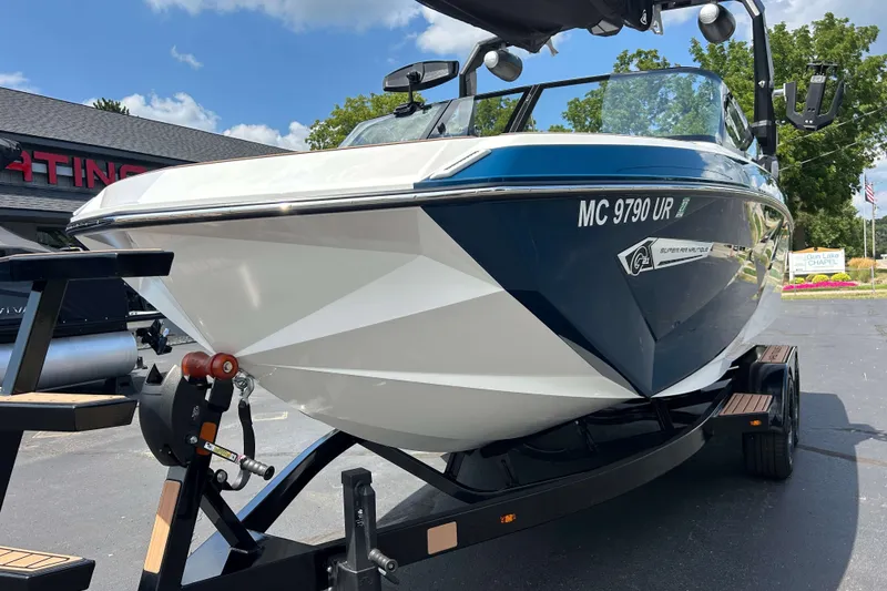 Slide: The Image of 2022 Nautique Super Air Nautique G21 boat on trailer, parked outdoors. - 21