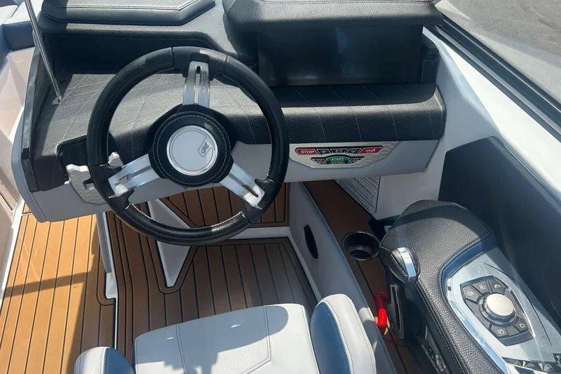 Slide: The Image of 2022 Nautique Super Air Nautique G21 steering wheel and dashboard, featuring modern controls. - 13