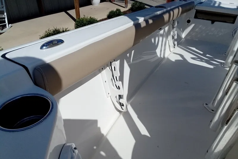 Slide: The Image of 2016 Key West 210 Bay Reef boat interior with cushioned seating and cup holder. - 21