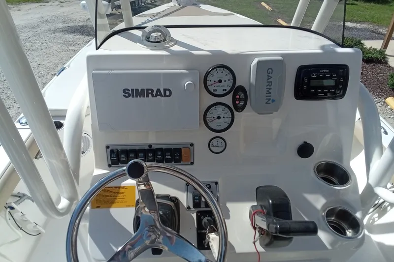 Slide: The Image of 2016 Key West 210 Bay Reef boat dashboard with Simrad and Garmin electronics. - 17
