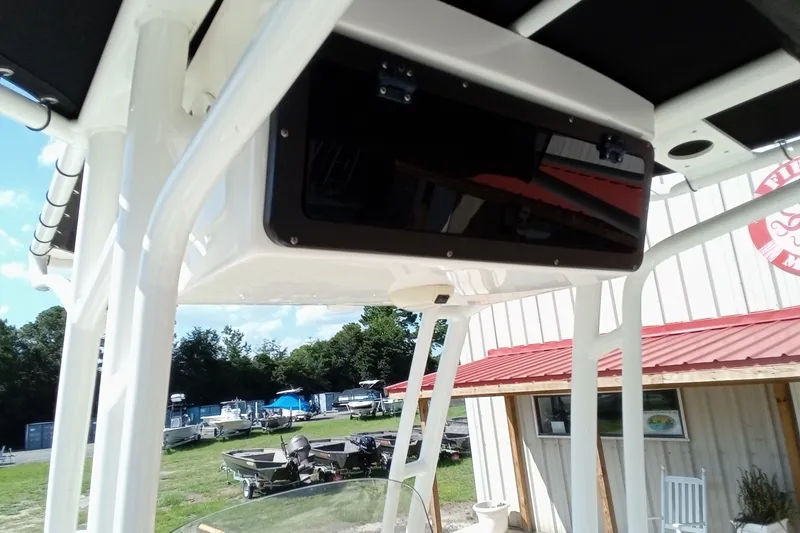 Slide: The Image of 2016 Key West 210 Bay Reef boat with T-top storage, outdoor setting. - 16