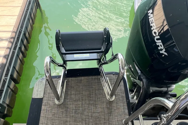 Slide: The Image of 2023 Harris Crowne SL 250 boat with Mercury engine and swim ladder. - 25