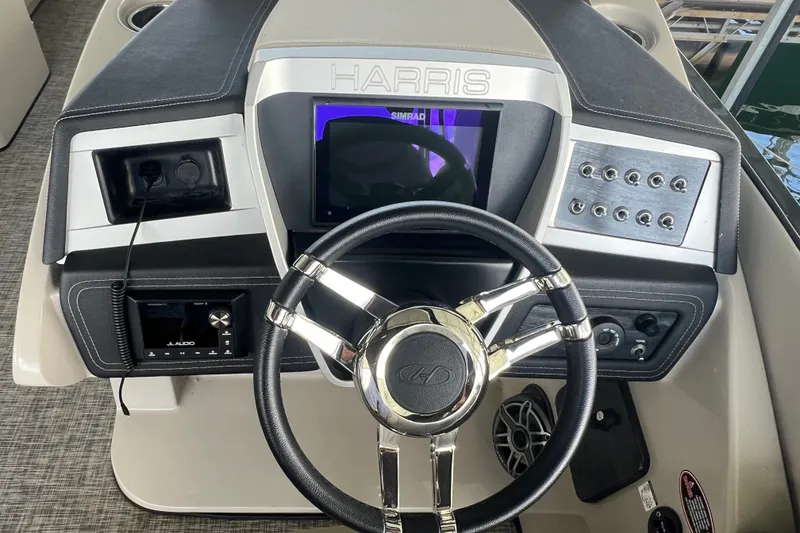 Slide: The Image of 2023 Harris Crowne SL 250 dashboard with steering wheel and control panel. - 20