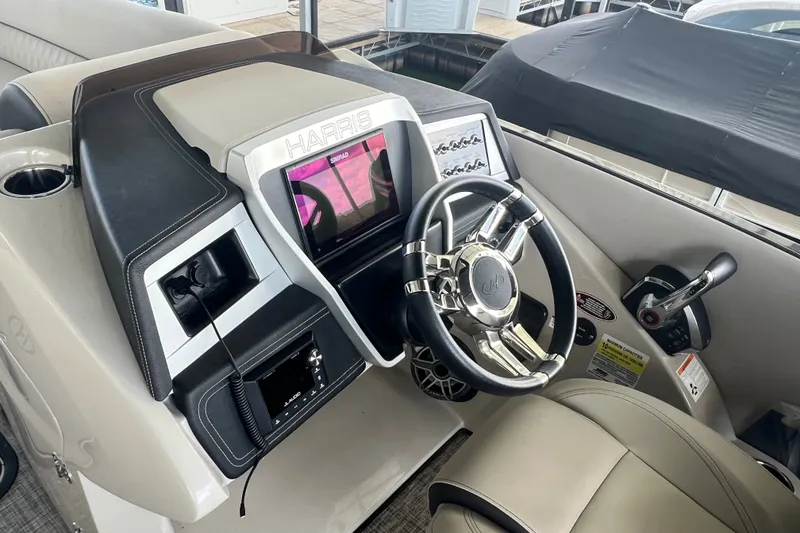 Slide: The Image of 2023 Harris Crowne SL 250 boat dashboard with steering wheel and control panel. - 18