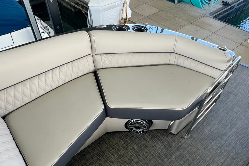 Slide: The Image of Luxurious seating on 2023 Harris Crowne SL 250 pontoon boat, featuring elegant upholstery and speaker system. - 15