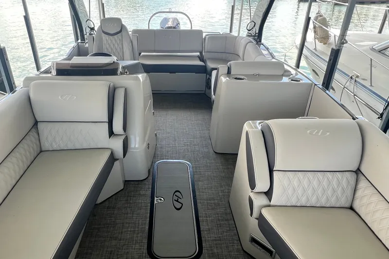 Slide: The Image of Luxurious interior of 2023 Harris Crowne SL 250 pontoon boat with plush seating. - 13