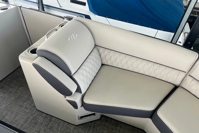Slide: The Image of Luxurious seating on 2023 Harris Crowne SL 250 boat with quilted upholstery and cup holders. - 14