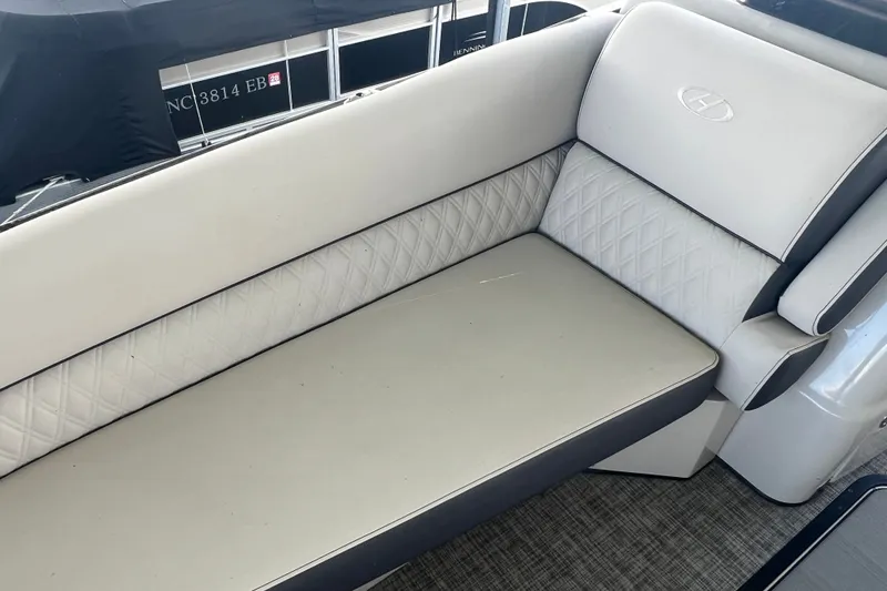 Slide: The Image of 2023 Harris Crowne SL 250 boat interior with luxurious white seating and quilted design. - 17