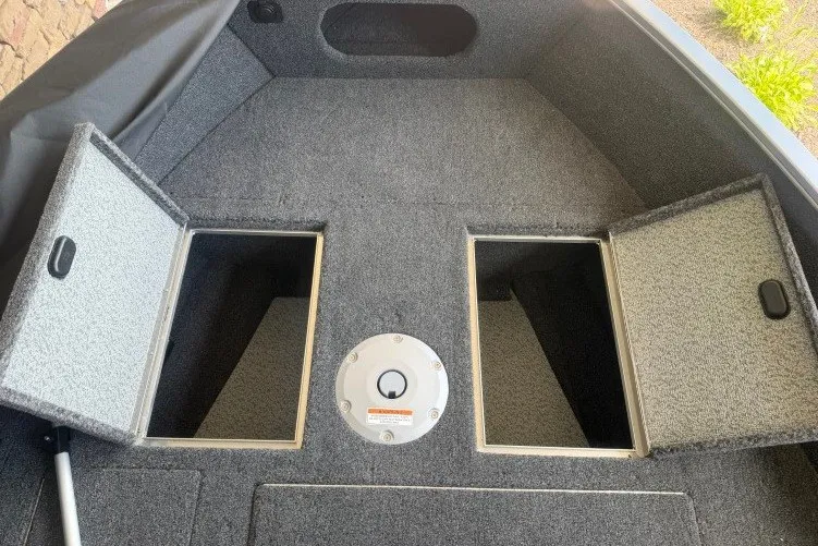 Slide: The Image of 2026 Crestliner 1650 Kodiak SC boat interior with open storage compartments. - 5